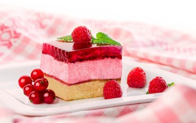 Appetizing cake with souffle and jelly with raspberry and currant berries