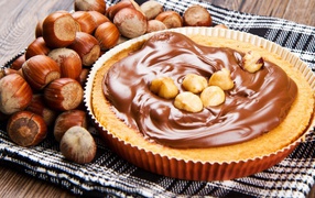 Appetizing pie with chocolate paste and hazelnuts