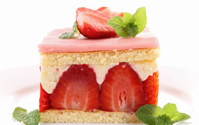 Appetizing piece of cake with strawberries and mint on a white background