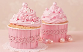 Appetizing sweet cupcakes with pink cream