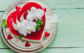 Beautiful cake in the shape of heart with white orchids