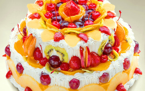 Beautifully decorated with berries and fruit cake with cream