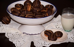 Biscuits with chocolate and milk on the table