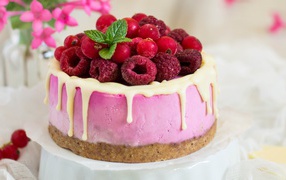 Cake with a soufflé and berries of raspberries and cranberries