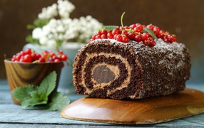 Chocolate roll with cream and red currants