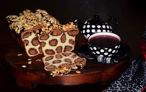 Delicious leopard cake on the table with a cup of tea