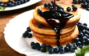Delicious pancakes with blueberries and jam