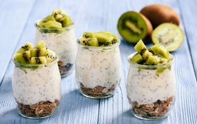 Dessert with oat flakes and yogurt in glasses with kiwi slices