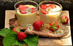 Dessert with yogurt and fresh strawberries in glasses on the table