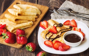 Pancakes with chocolate and strawberries