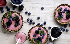 Pudding with blueberries and blackberries on the table
