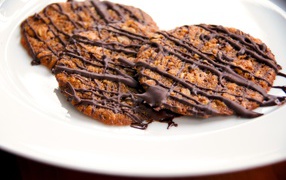 Round biscuits with chocolate on a white plate