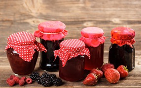 Strawberry, blueberry and raspberry jam in jars