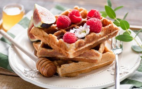 Sweet waffles with honey, raspberries and figs