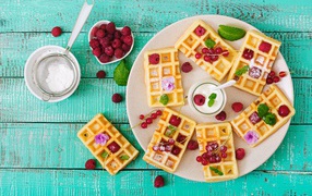 Wafers with raspberries and red currants on a plate