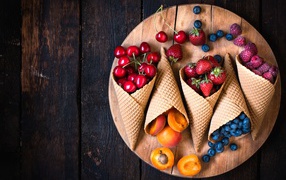 Waffle horns with strawberries, raspberries, cherries and blueberries