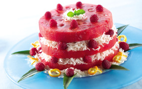 Watermelon cake with coconut shavings and raspberry berries