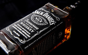 A bottle of whiskey Jack Daniels on a black background