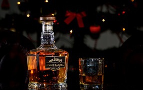 A bottle of whiskey Jack Daniels with a glass