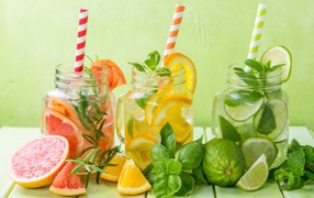 Citrus cocktails in jars with straws