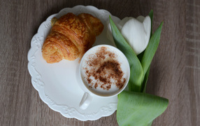 Croissant, cappuccino and white tulip for your beloved