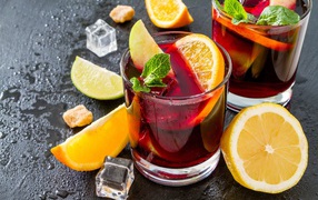 Drink in glasses with lemon, mint and ice slices
