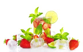 Drink with strawberries, lime, mint and pieces of ice on a white background
