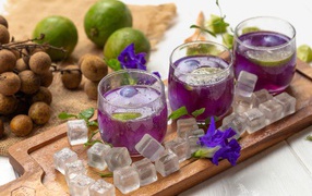 Glasses with a drink on the table with lime and ice cubes