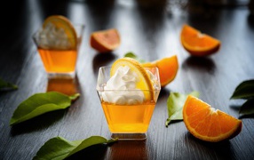 Orange cocktail with cream on the table