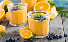 Orange juice in a glass with blueberries
