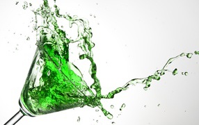 Splashes of green cocktail on a gray background