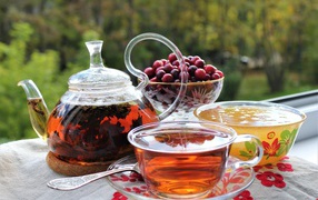 Tea on the table with honey and berries