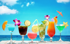 Tropical cocktails on blue sky background