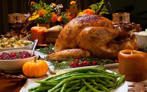 Appetizing baked chicken with green asparagus and refreshments on the festive table