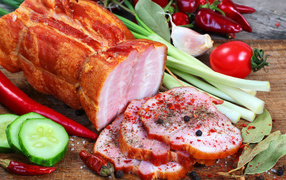 Appetizing ham with spices and fresh vegetables on the table