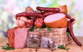 Appetizing sausage in a basket on a table with spices