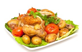 Baked chicken with potatoes and tomatoes on white background