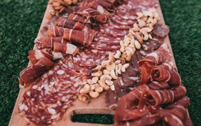 Cold cuts with nuts on a cutting board
