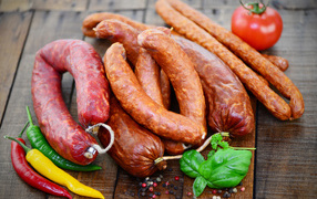 Fresh sausages with pepper on the table