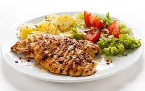 Grilled chicken breast with vegetables on white background