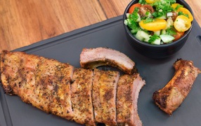 Grilled ribs with salad on the table