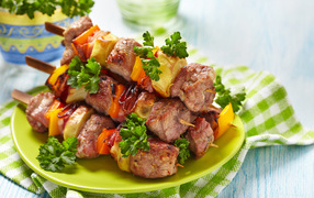 Shish kebab with vegetables on a plate on a table