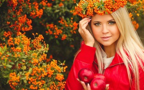 Beautiful blonde with a wreath of ashberry on her head