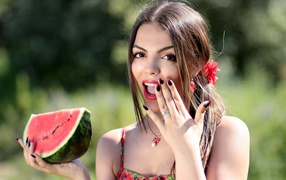 Beautiful bright girl with a watermelon in her hand