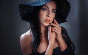 Beautiful brunette in a big black hat
