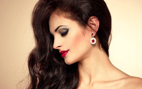 Beautiful brunette with expensive earrings in the ears