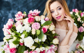 Beautiful gentle girl blonde with a big bouquet