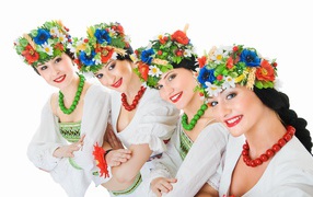 Beautiful girls in folk costumes with wreaths on their heads