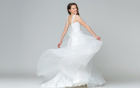 Beautiful joyful girl in white wedding dress