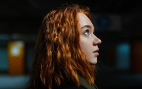 Beautiful red-haired girl side view